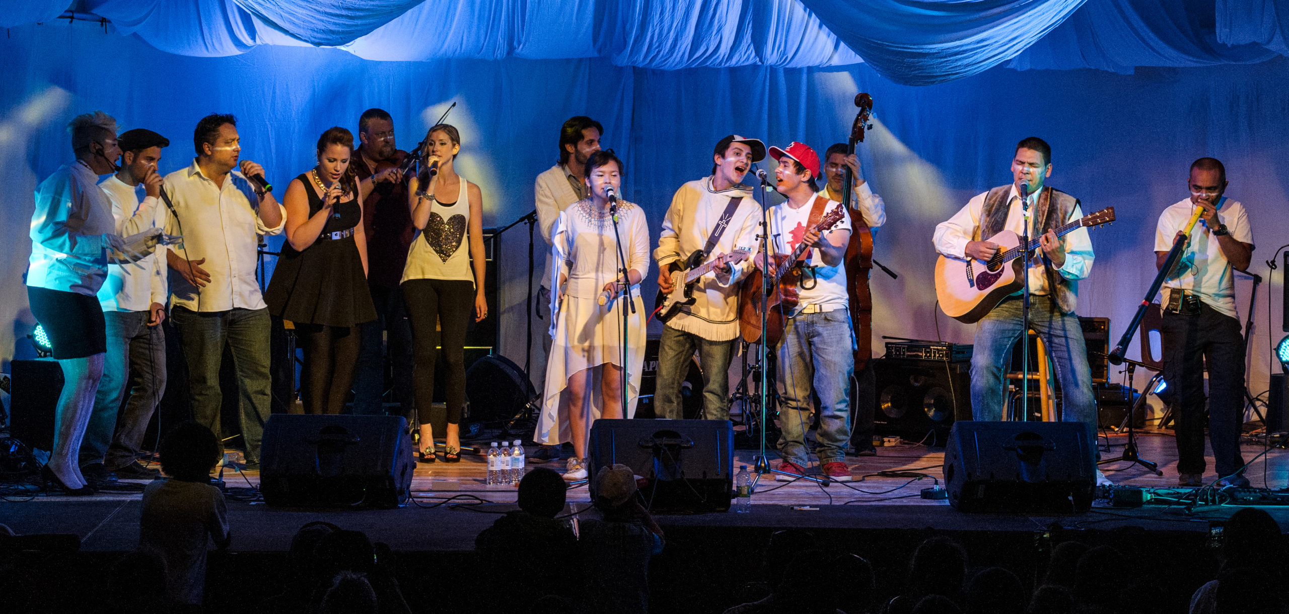 A group of performers on stage singing